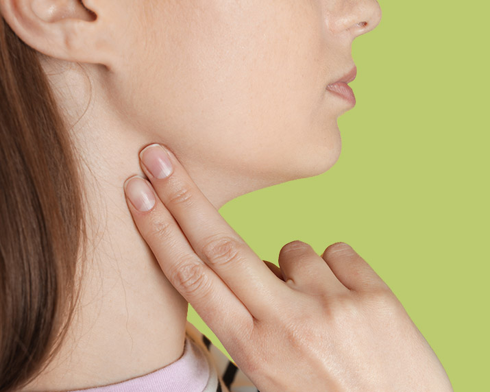 woman with her fingers on neck taking her pulse