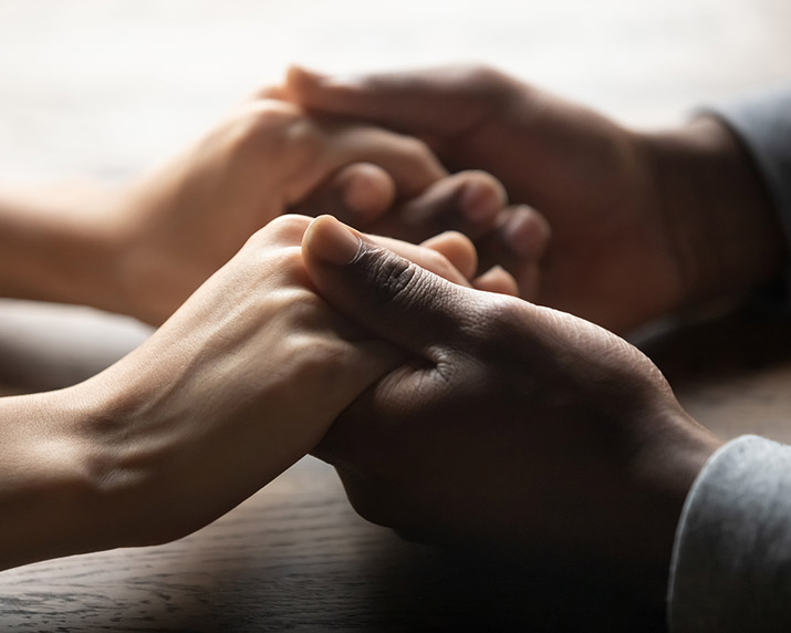 hands comforting a person experiencing grief