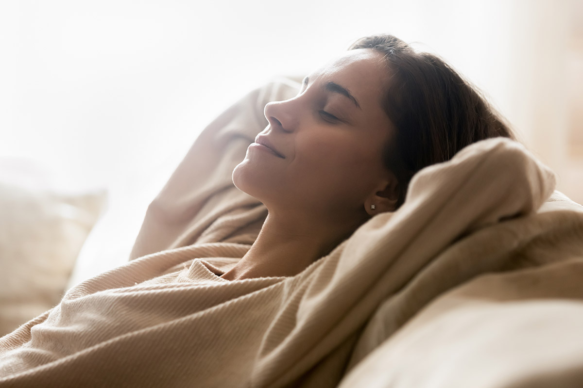 Woman with closed eyes and a content look in her face