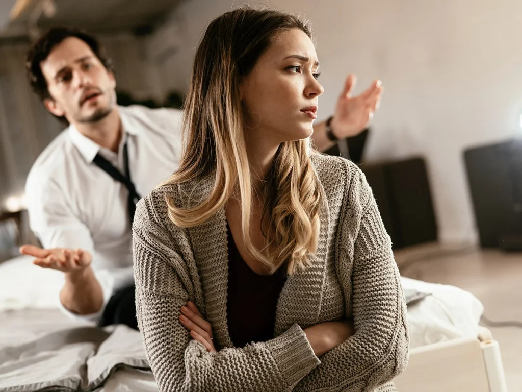 upset woman ignoring confused man